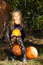 Little girl posing in autumn forest. Funny kid in carnival costume at Halloween trick or treat