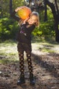 Little girl posing in autumn forest. Funny kid in carnival costume at Halloween trick or treat