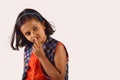 Little girl posing in front of camera with finger on lip in thinking pose. Pune, Maharashtra Royalty Free Stock Photo