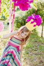 Little girl posing with a toy crown on the children's holiday outdoors