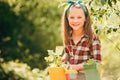 Little girl Potted. Garden tools. Child Farmer planting in the vegetable garden. Carefree childhood.