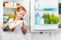 Little girl pouring milk in glass Royalty Free Stock Photo