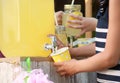 Little girl pouring natural lemonade into cup. Summer refreshing drink Royalty Free Stock Photo