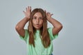 Little girl pout lips and showing horns gesture Royalty Free Stock Photo