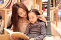 Little girl practice reading in the Brilliantly illuminated Market Royalty Free Stock Photo