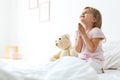 Little girl praying in bed at home Royalty Free Stock Photo