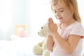 Little girl praying in bed at home Royalty Free Stock Photo