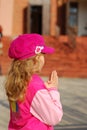 Little girl praying in front of church Royalty Free Stock Photo