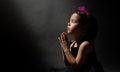 Little girl praying, isolated black background Royalty Free Stock Photo