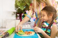 Little girl preparing a cookie on kitchen for her mother