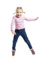 Little girl of preschool age in a pink sweater and jeans is jumping. Isolated over white background