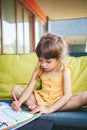 Little girl preschooler writing numbers in the study book
