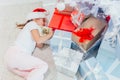 Little girl with present sleeping under Christmas tree Royalty Free Stock Photo