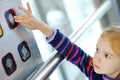 Little girl pressing elevator button with her finger. Child reaching to push a button in a lift Royalty Free Stock Photo