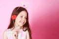 Little girl princess, lip, crown, isolated on pink background. Celebrating carnival for kids, birthday party. Cute Royalty Free Stock Photo