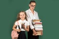 Little girl in private school, pupil and teen schoolgirl. Lesson and reading grammar book.