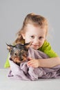 Little girl with puppy after his bath