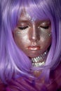 A little girl in a purple wig with silver sequins on her face. An alien, fantasy world.A fairy or an alien. Eyes closed