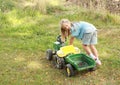 Little girl pushing a tractor