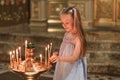 A little girl puts a candle in church. Orthodoxy Royalty Free Stock Photo