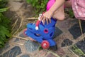 A little girl puts on roller skates sitting on the steps of her country house Royalty Free Stock Photo