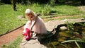 Little girl puts on rubber boots