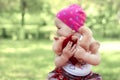 Little girl puts a Teddy bear on his hands