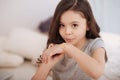 Little girl putting adhesive bandage on her injury at home Royalty Free Stock Photo