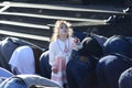 Little girl putting her hand up, looking at sky and praying in front of muslim men kneeling Royalty Free Stock Photo