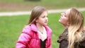 Little girl putting her hands through her mother's hair