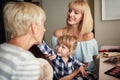 Little  girl putting makeup on face to her grandma Royalty Free Stock Photo