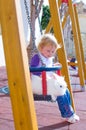 Little girl and rabbit on swings