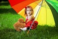 Little girl with a rainbow umbrella in park Royalty Free Stock Photo