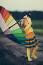 Little girl with rainbow umrella in the field Royalty Free Stock Photo