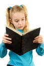 Little girl is reading the Bible Royalty Free Stock Photo