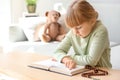 Little girl reading Bible at home Royalty Free Stock Photo