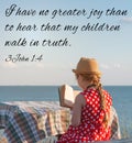 Little girl reading Bible on sea background. Quotes for believers. Inspirational Christian verse. Love people care faith Royalty Free Stock Photo