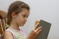 Little girl reading big book Royalty Free Stock Photo