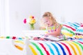 Little girl reading a book in bed Royalty Free Stock Photo