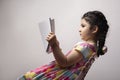 Little girl reading a book with blank cover in front of body mock-up series