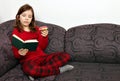 Little girl reading a book and eating a donut Royalty Free Stock Photo