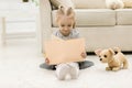 A little girl reading a book on the floor. Royalty Free Stock Photo