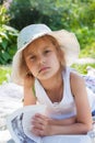 Little girl reading a book in the garden Royalty Free Stock Photo