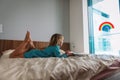 Little girl reading book at home, kid staying safe during quarantine