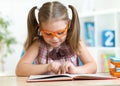 Little girl reading a book