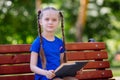 Little girl reading a book outdoors. Royalty Free Stock Photo