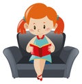 Little girl reading book on sofa