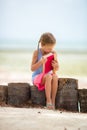 Little adorable girl with book on tropical white beach Royalty Free Stock Photo