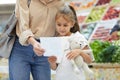 Little Girl Reading Shopping List Royalty Free Stock Photo