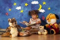 Little girl reading stories to her stuffed toy friends
